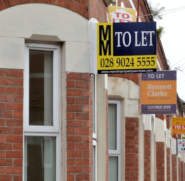 Row of houses with To Let signs.