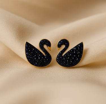 a pair of black swan - shaped earrings with black crystals