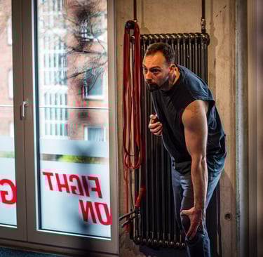 a man in a black shirt is holding a red rope