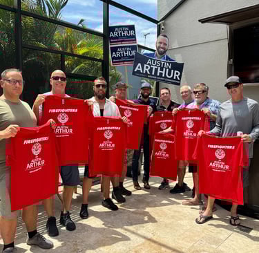 Firefighters showing support for Austin Arthur by holding Firefighters for Austin Arthur shirts in C