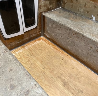 staring at the companionway door, the unfinished marine plywood cockpit with thickened epoxy fillets