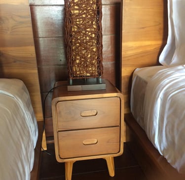a nightstand with a basket weave basket on top of it
