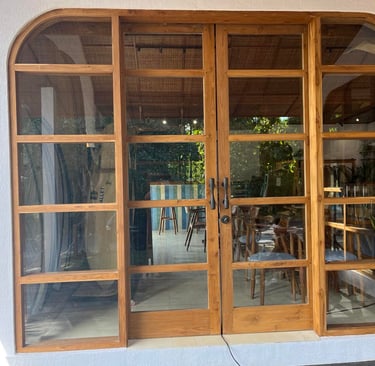 a large open door with a table and chairs