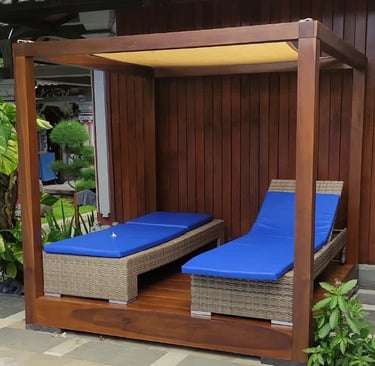 a couple of lounge chairs sitting next to a pool