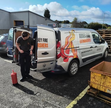 One of Abbey Fire employee's gearing up for a job with the Abbey Fire Van in the background.