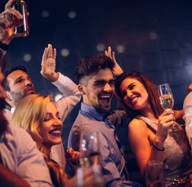 Group of friends enjoying a Las Vegas club crawl, celebrating with drinks during an exciting nightlife experience.