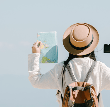 a woman in a hat and a backpacker holding a map