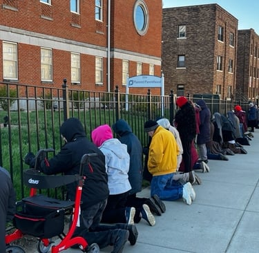 A group of people peacefully praying in front of planned parenthood