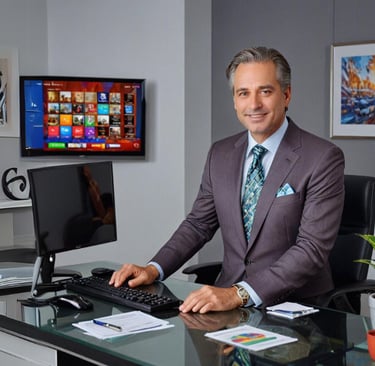 THE MAN in a suit and tie is sitting at a desk