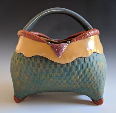 pottery basket by Julie Cunningham in turquoise, amber, and rust