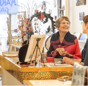 artist associates chattinbg in the gallery