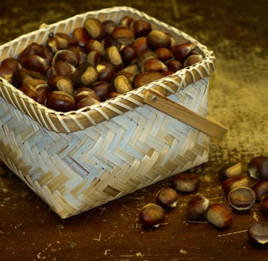 A basket of chestnuts on a brown table