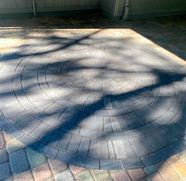 Stamped concrete vs. wood decking vs. natural stone patio comparison.