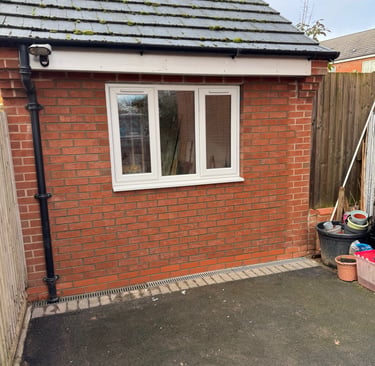 Front view of converted garage showing new window and brickwork