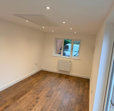 Inside converted garage showing new window to front