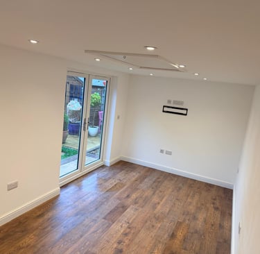 Inside converted garage with French doors and spotlights