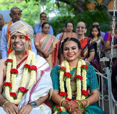 Couples sitting on oonjal on Brahmin wedding