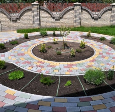 beautiful stamped concrete garden driveway with plants in the centre for aesthetics