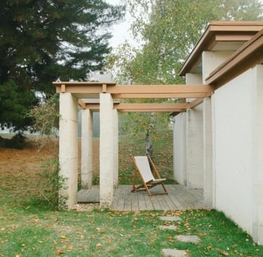 Simple, stamped concrete gazebo with a wooden chair