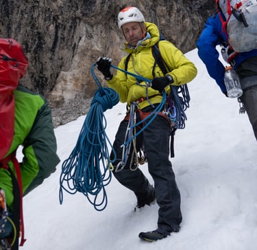 Climber Timmy Oneill prepares a rope for descent in a steep gully in the Italian Dolomites