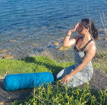 woman on a cliff using yoga materials