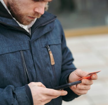 a man in a blue jacket and a black hat