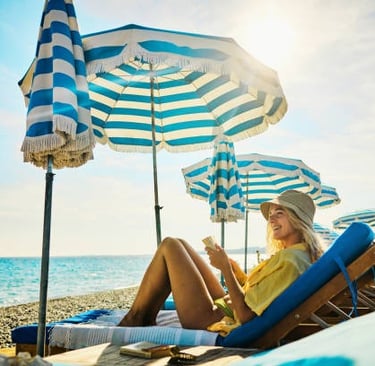 a woman sitting on a beach chair with a book