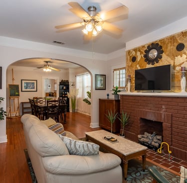 a living room with a fireplace and a television