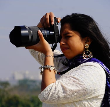 a woman in a white shirt and blue scarf