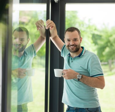 a man is holding a cup of coffee and a cup of coffee
