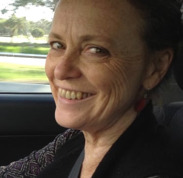 a woman in a car smiling at the camera