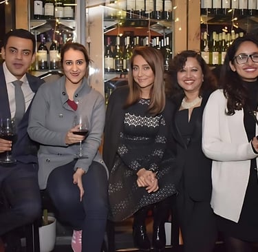 a group of people standing around a bar