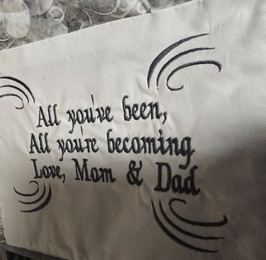 Close-up of custom embroidered label sewn into a handmade memory quilt