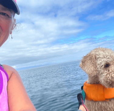 woman and dog on ocean