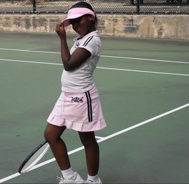 Image of Valicia Carmen at about 8 years old, on a tennis court in Brooklyn, NY