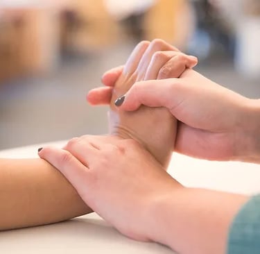 therapist stretching a patient's wrist