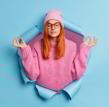 a woman in a pink sweater and glasses is looking at the camera
