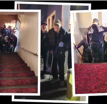 Local firefighters in uniform delivering a steak dinner from The Hammond Steak House to a veteran in