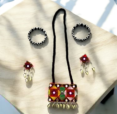 a necklace and earrings on a table