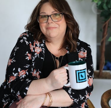 a woman sitting on a chair holding a mug
