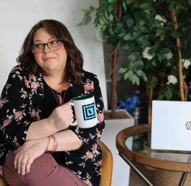 a woman sitting in a chair with a mug of coffee