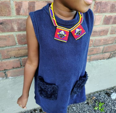 a young girl with a colorful necklace which is the part of the traditional regalia of Eswatini