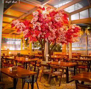 a large tree with flowers in a restaurant