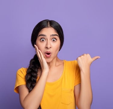 a woman with a surprised Lanka ads look on her face and holding her hands up to her