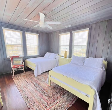 Painted yellow bedroom set with with a chair, picture frame and nightstand.