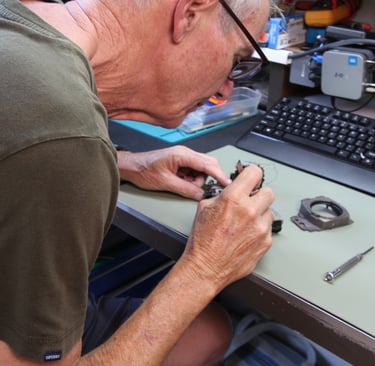 Camera technician inspects damaged camera