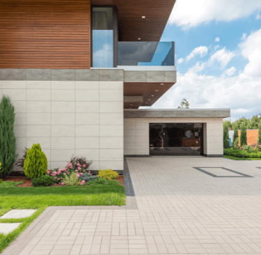 a beautiful house with a large stamped concrete driveway