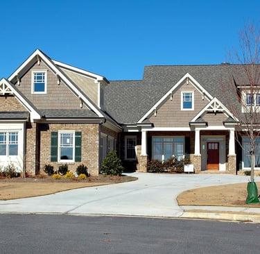 a beautiful house with big driveway and sidewalk