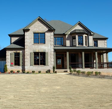 a large house with a large concrete driveway 