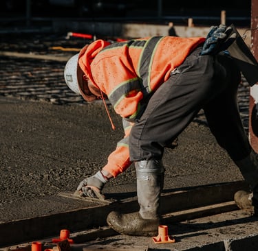 a construction worker is working on a concrete slab